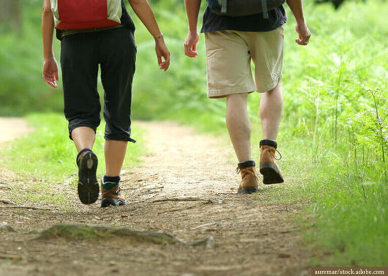 two people hiking side-by-side - auremar/stock.adobe.com