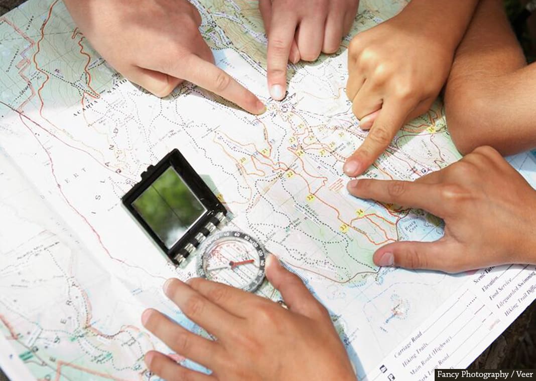 looking at map and compass - Fancy Photography / Veer