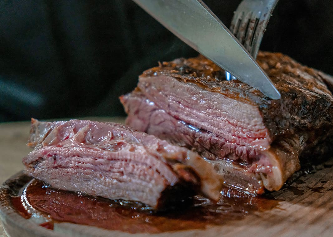 slicing meat - photo by José Ignacio Pompé on Unsplash